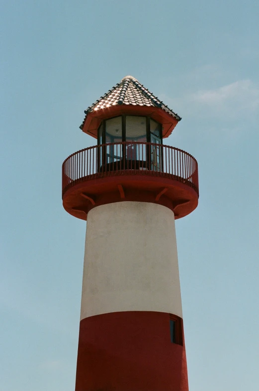 an old lighthouse with red and white trim