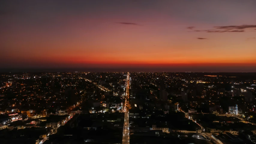 the view of the city at night from the top of the building