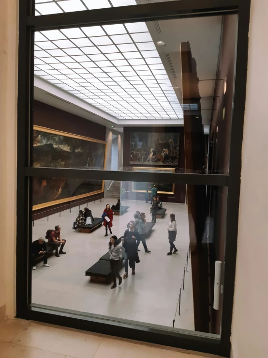 a museum is reflected in the window of a large building