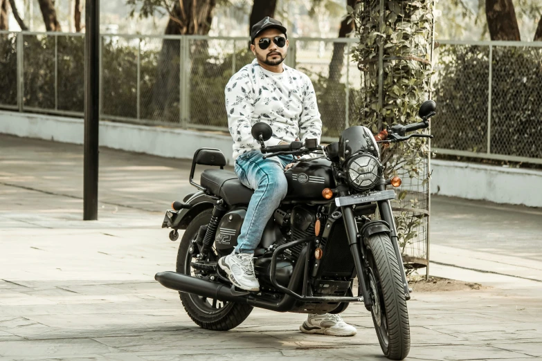 man sitting on a motorcycle in the street