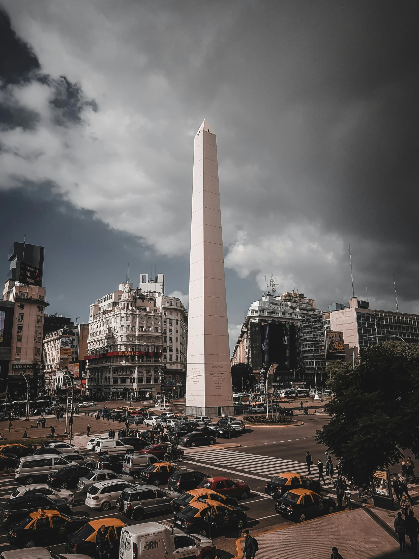 a large obelisk towering over a busy street