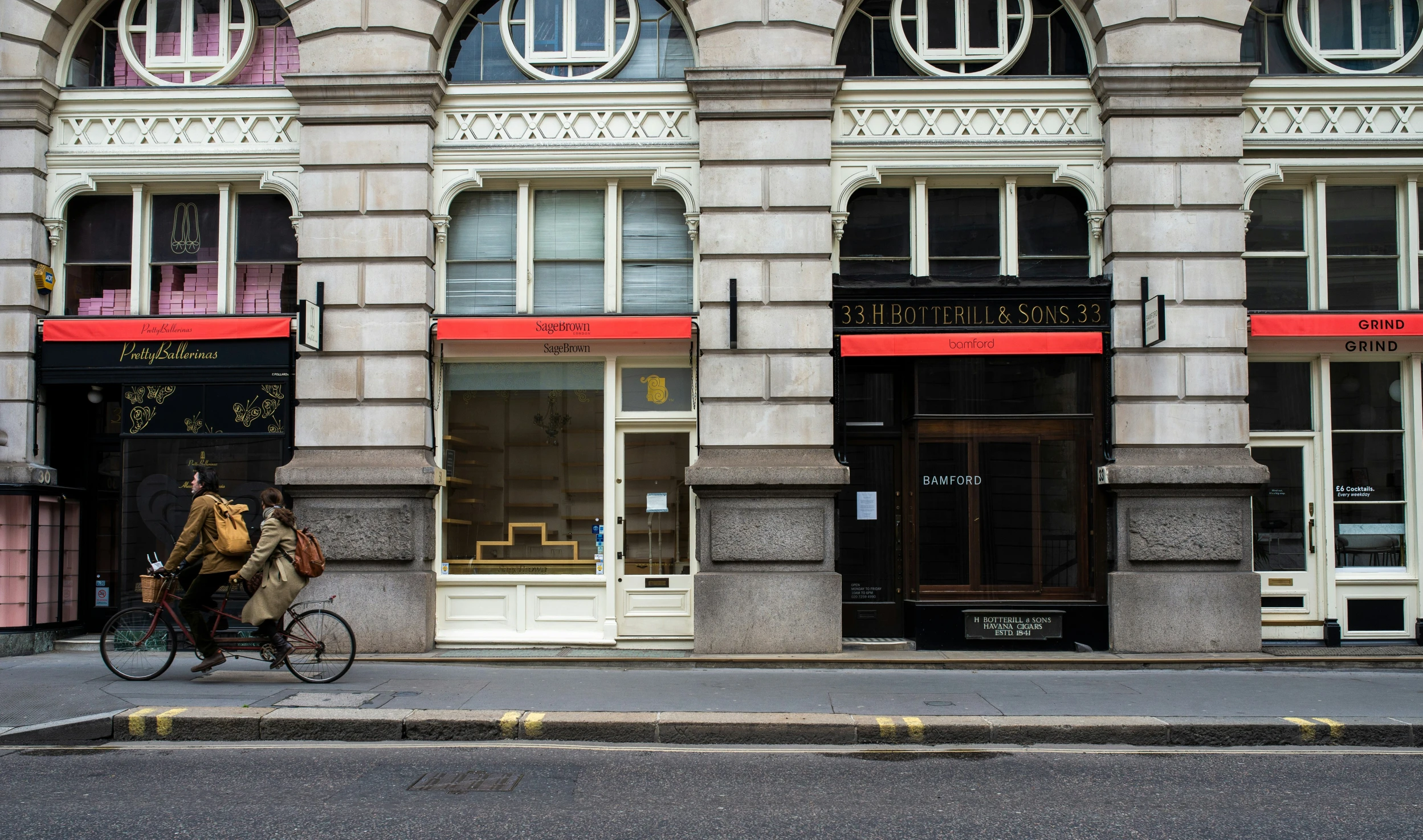 a man riding a bicycle past a building