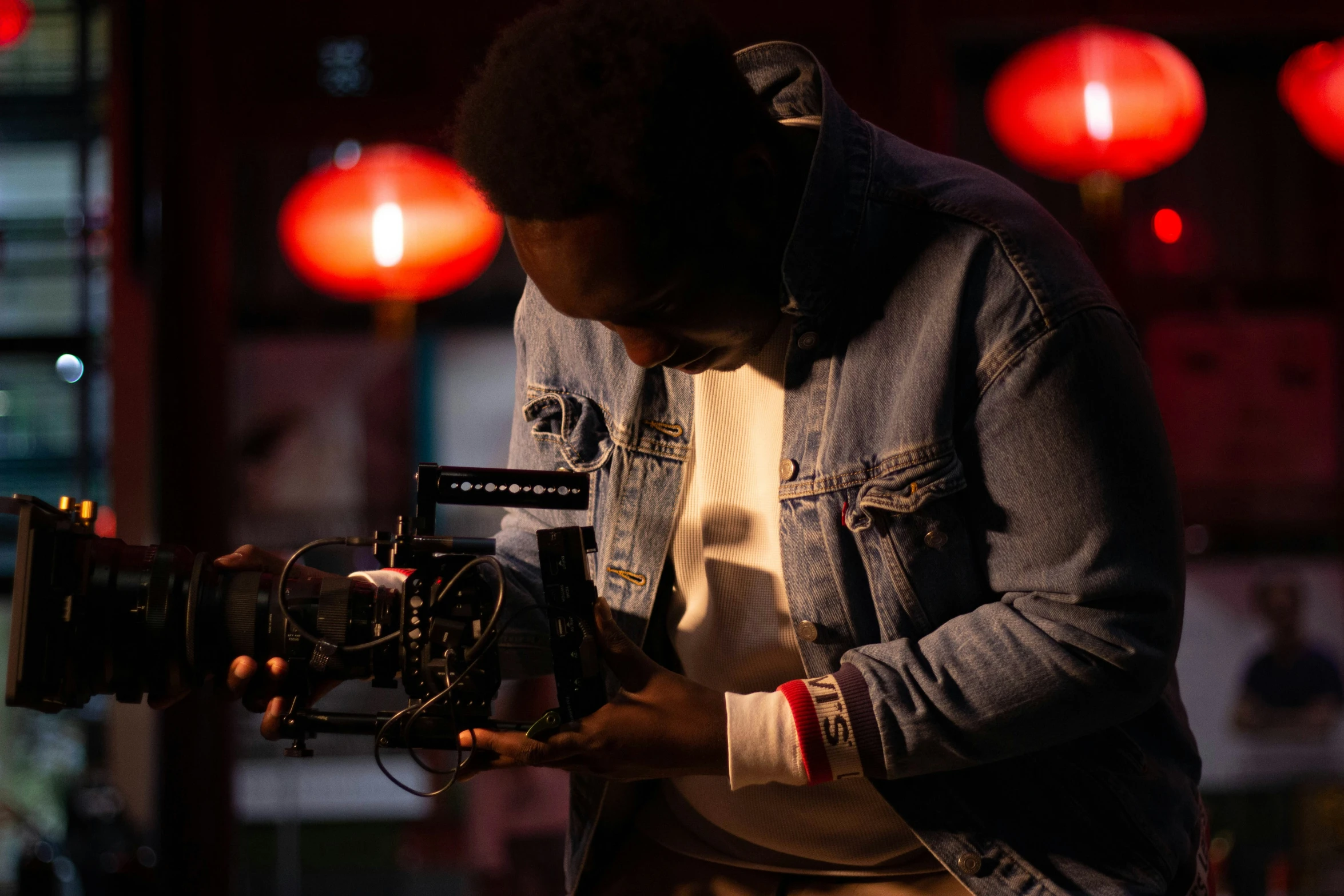 a man standing in front of a camera holding it up