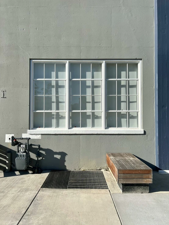 the side of a building with a fence, and a metal box