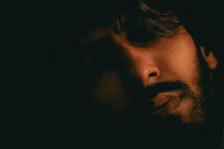 close up of a man with dark hair and beard