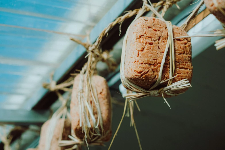 four rolls of bread hanging from a wire