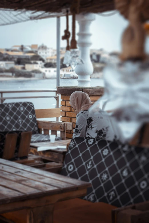 a couple of tables sitting on top of a wooden pier