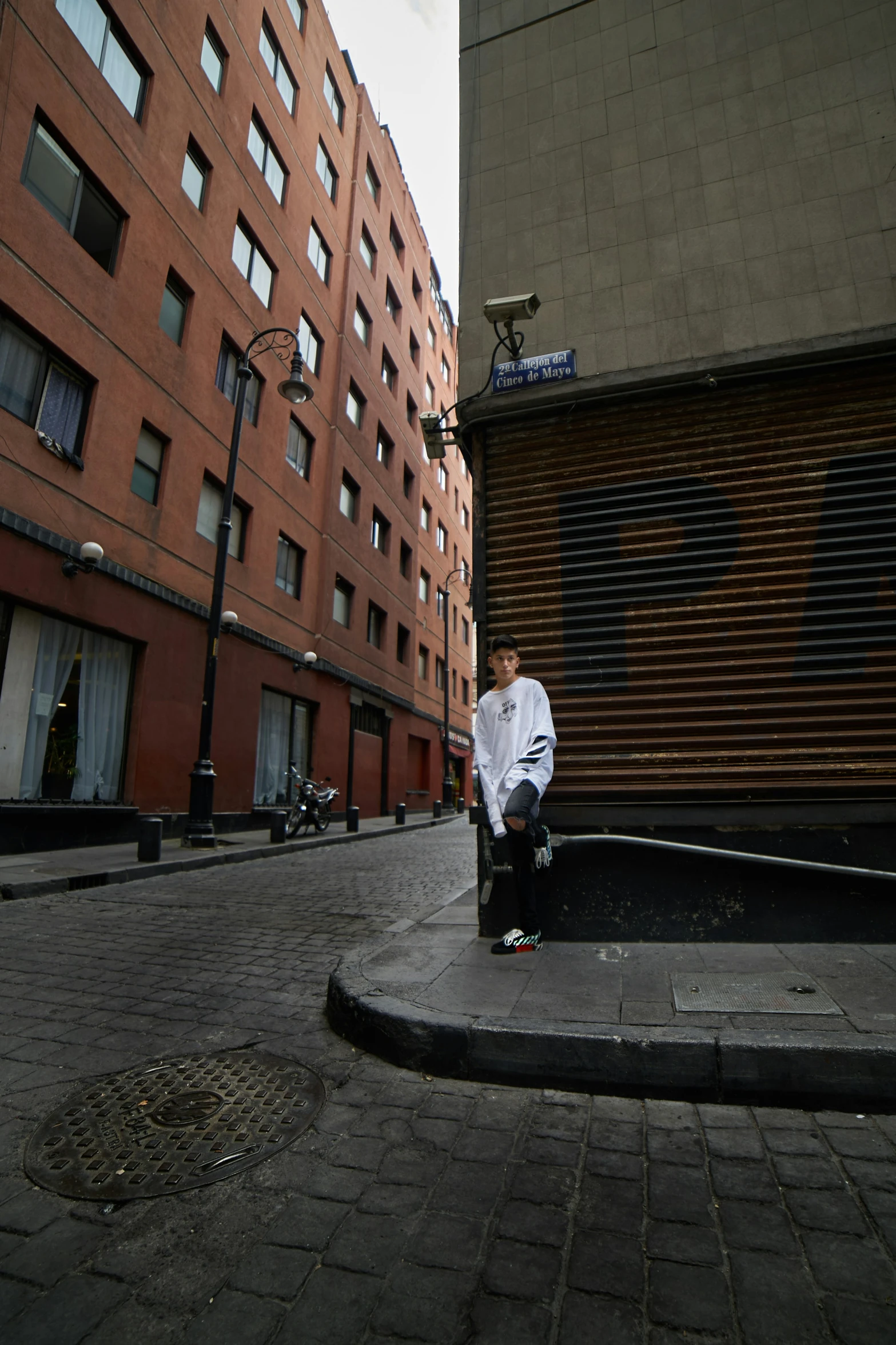 a man on a skate board sitting in front of some buildings