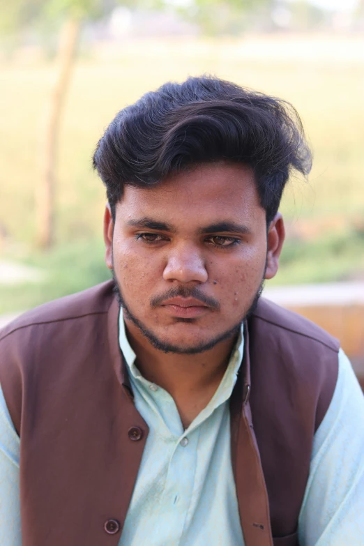 a close up of a person wearing a vest and tie