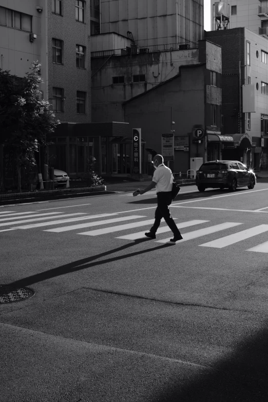 a man crossing the street with a skateboard