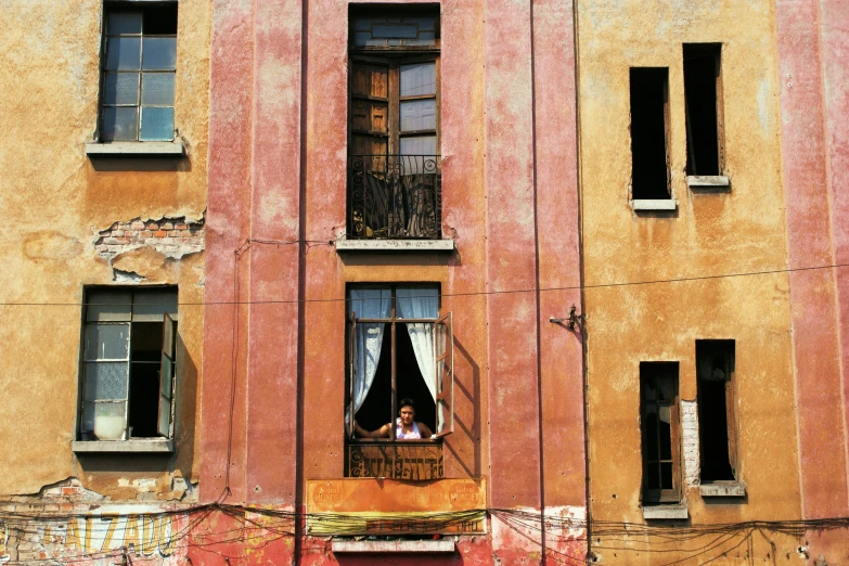 someone taking pictures through their windows in an old building