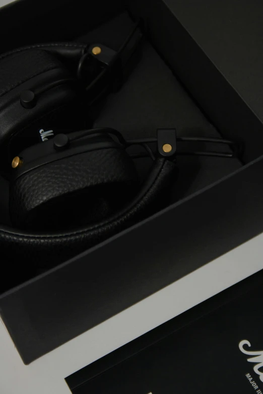 two leather headphones are in a box