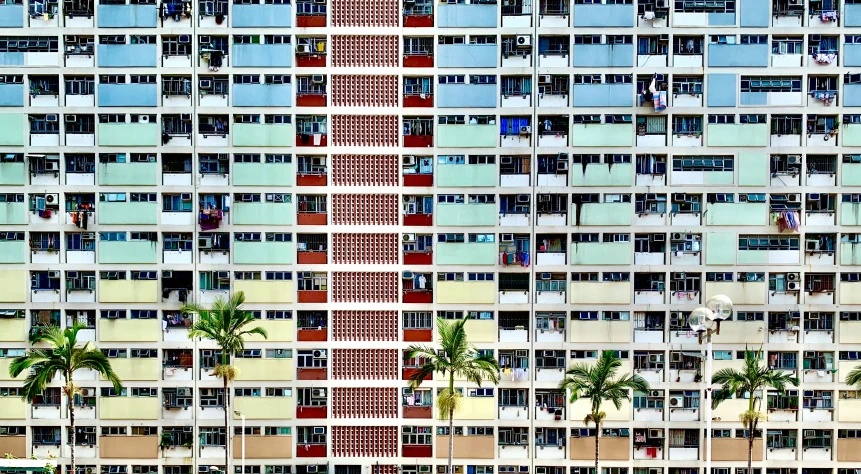 a very big multi - colored building near palm trees