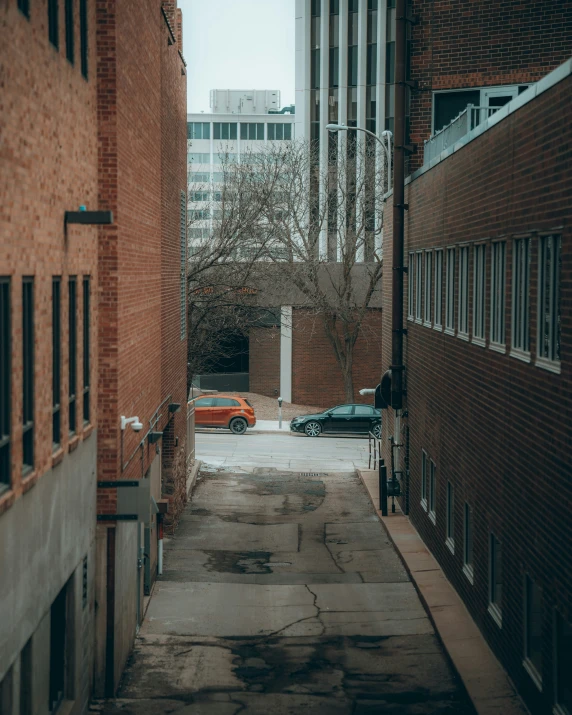 an alley next to some large buildings and brick buildings