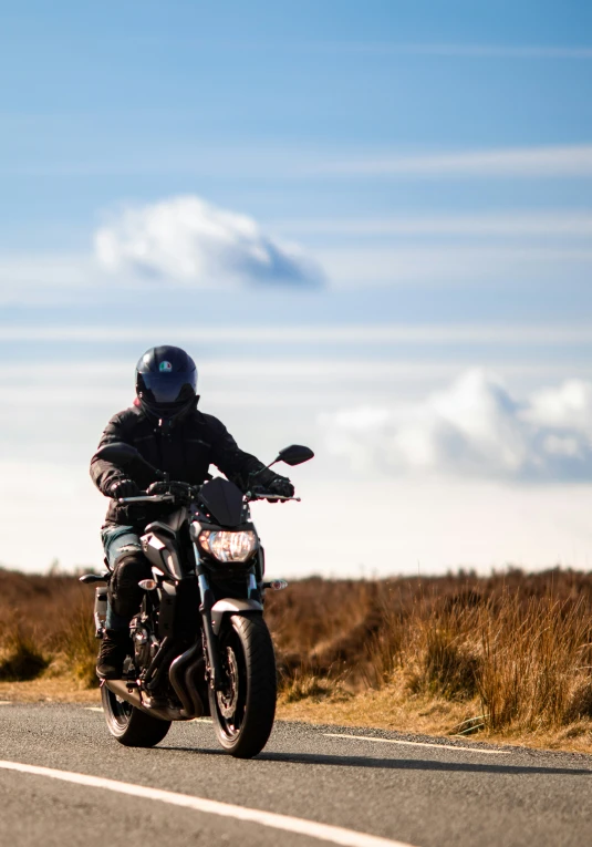 person on a motor cycle traveling down the country side