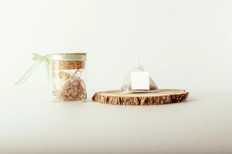 a wooden tree slice is next to a small jar