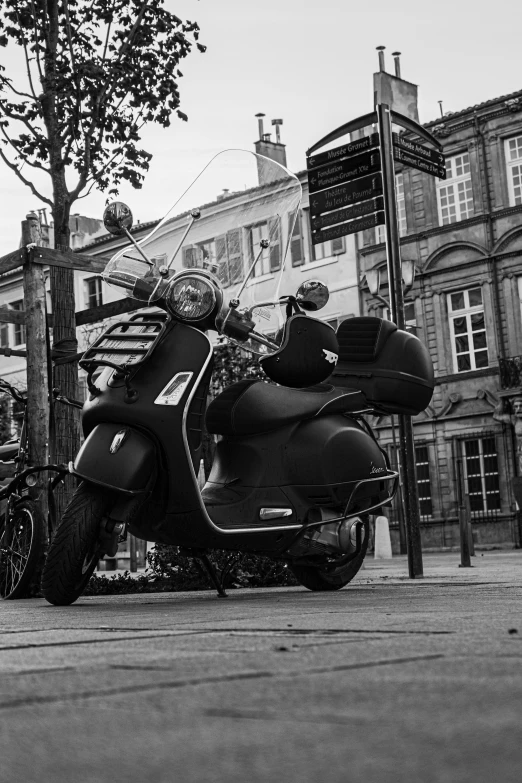 an old motor bike parked on the side of a road