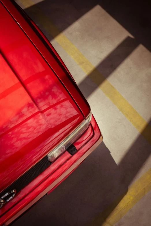 there is a red car parked in the driveway