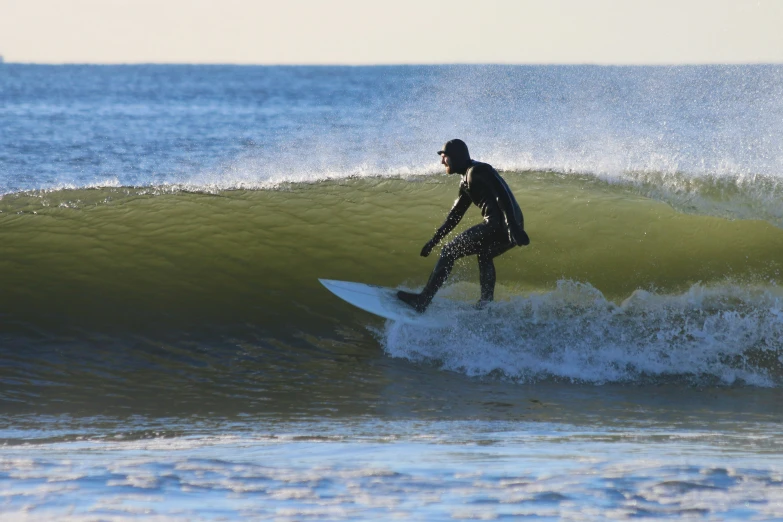 a man on his surfboard riding a wave