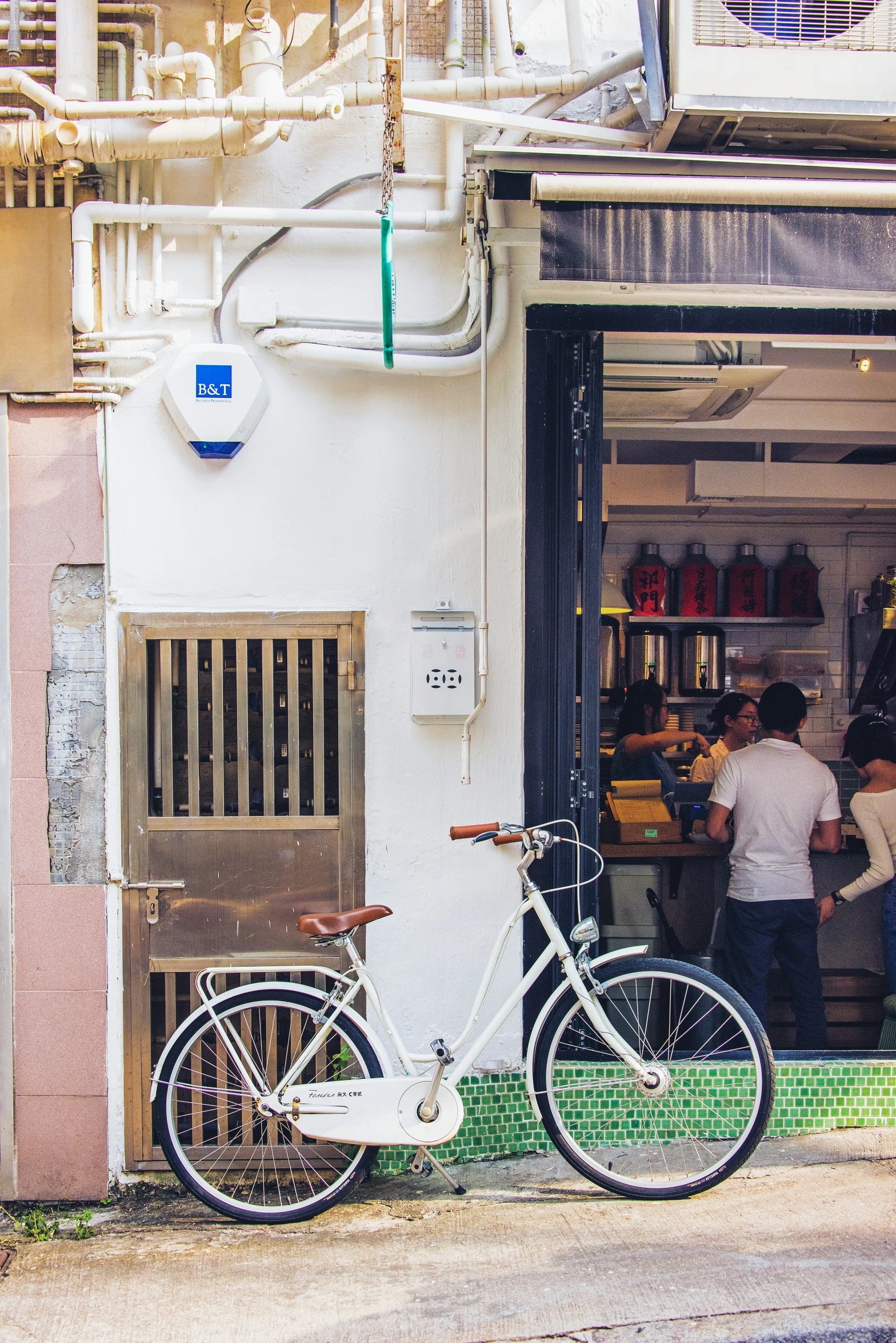 a bike parked outside a business with people walking in