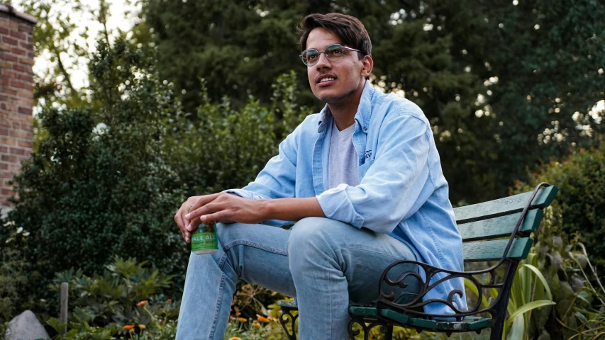 a man is sitting on a park bench