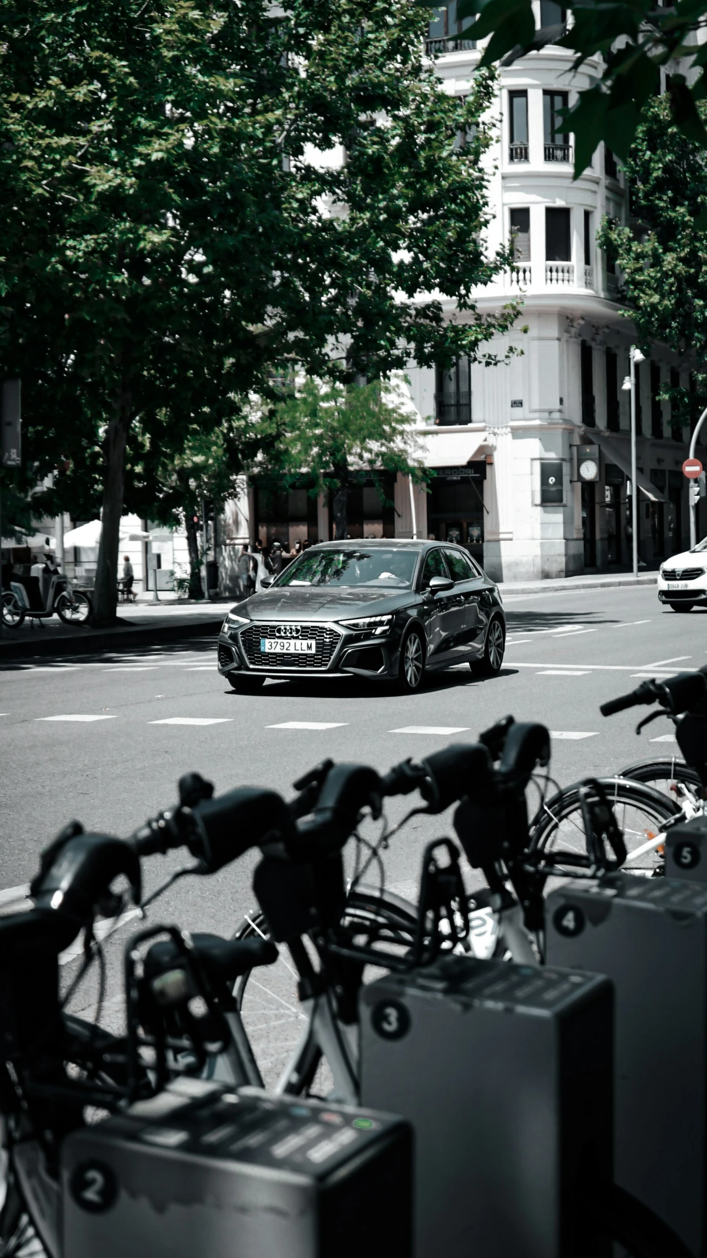 a car parked on the side of a road with bicycles in front