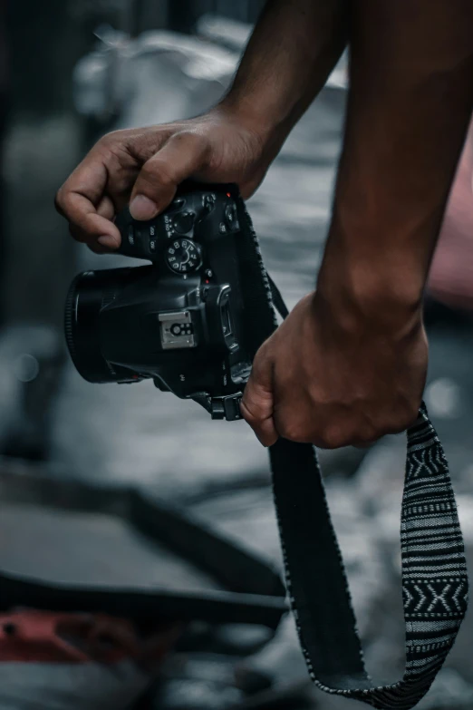 a man holding his camera strap