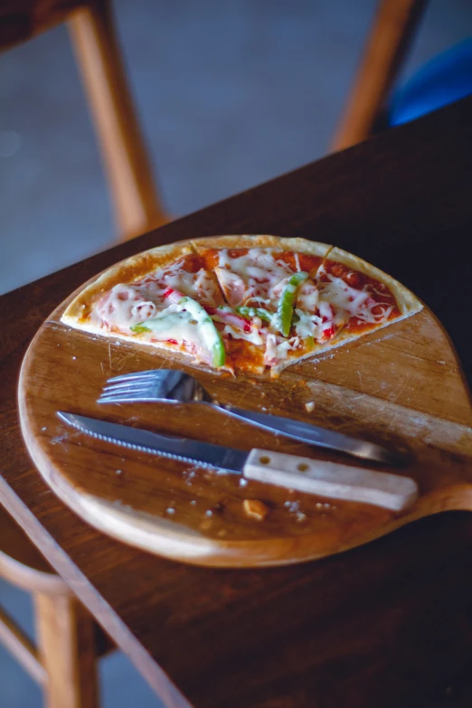 a small  board with a pizza on it