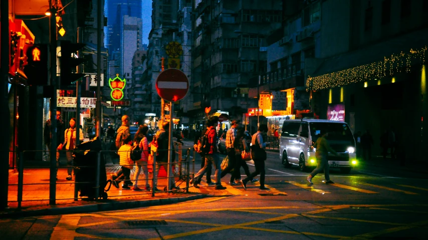 there are people walking in the street at night