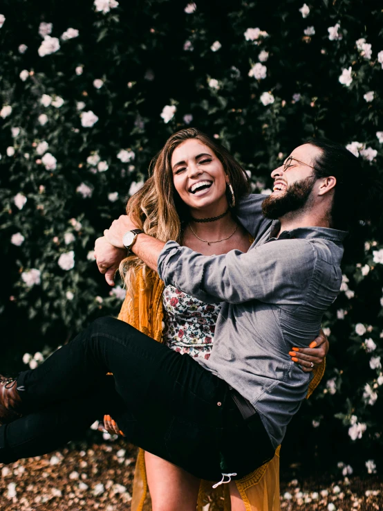 a couple in love in front of white roses