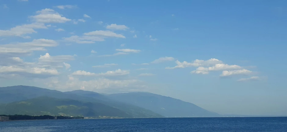 an airplane flying over some blue water