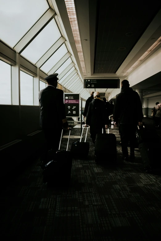 some people standing around with their luggage in hand