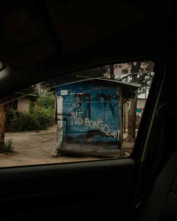 there is a blue out house in the dark