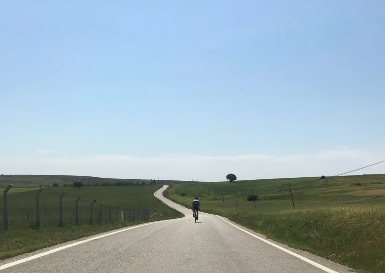 a man on his bike riding down the road