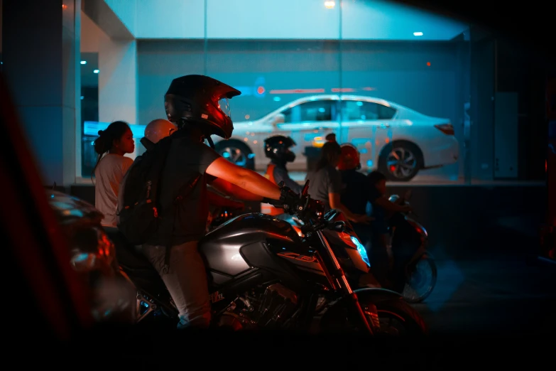 a motorcyclist wearing a helmet is stopped at the traffic light