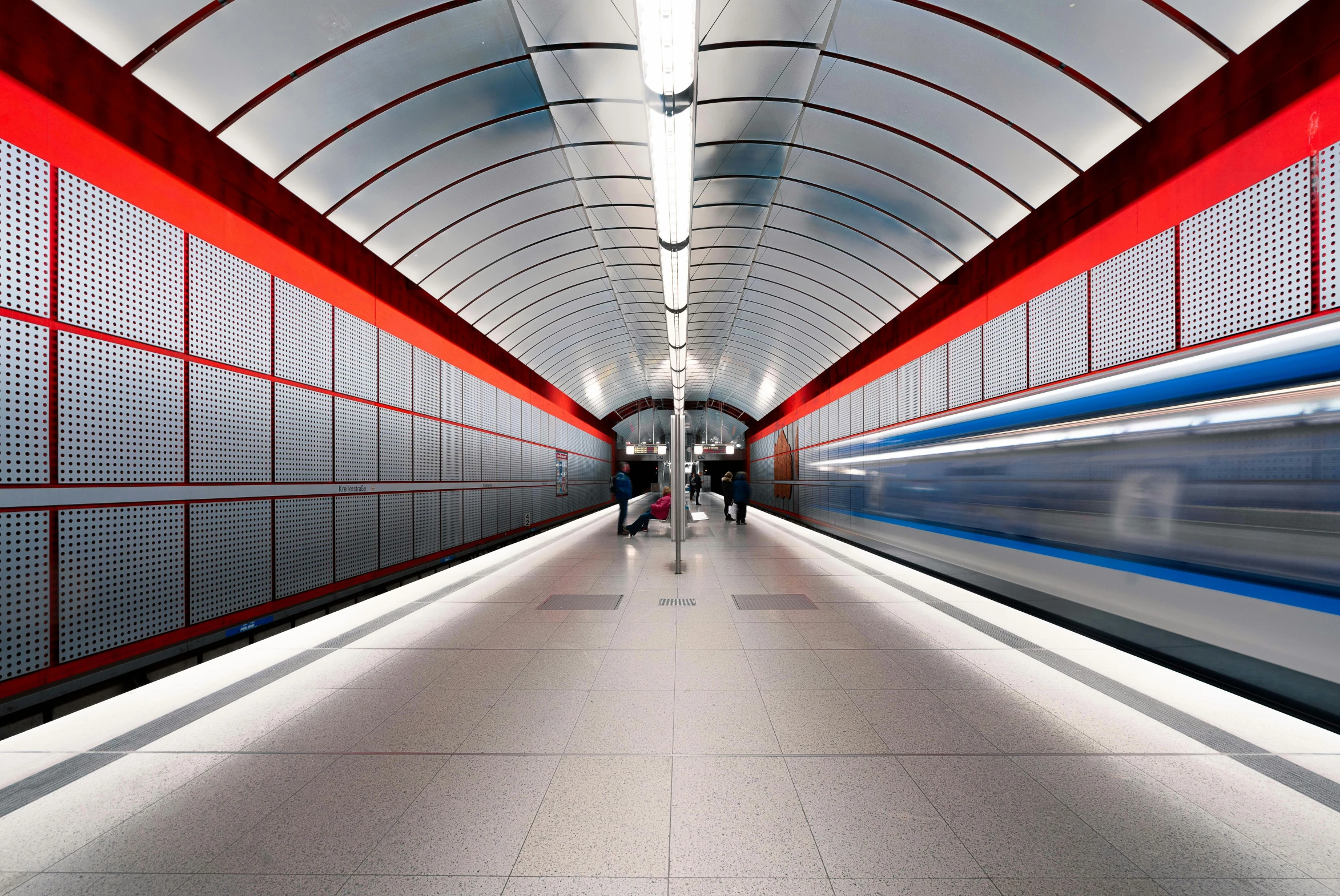 people are walking on a long platform