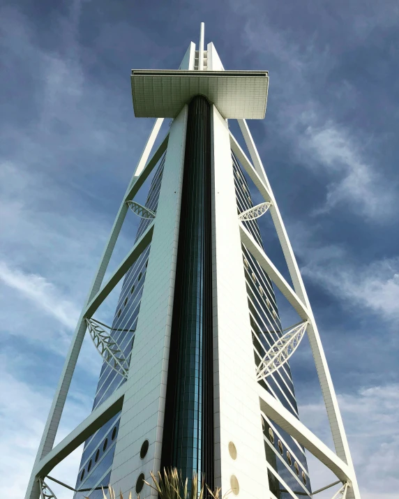 a tall white tower with a sky background