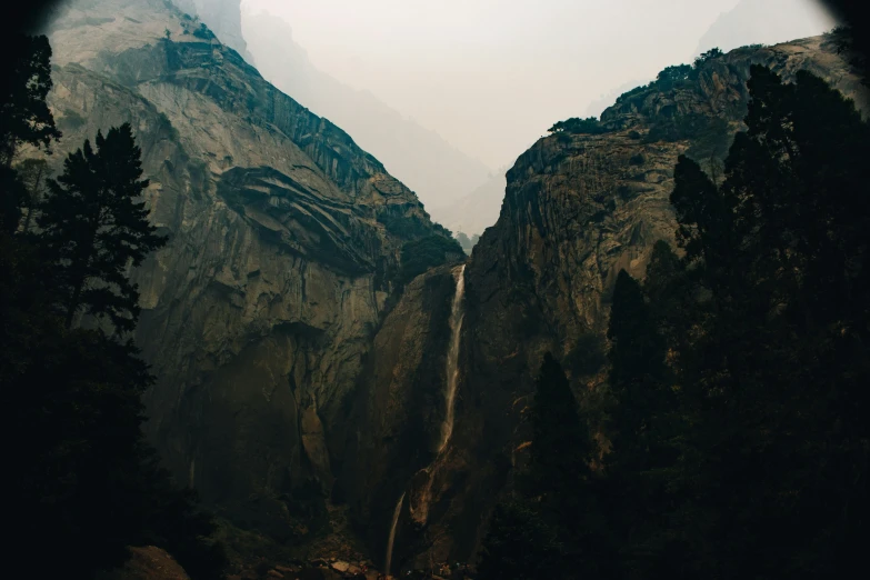 waterfall flowing between two mountain ranges in the woods