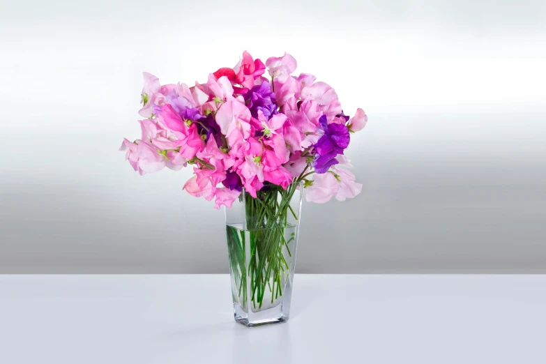 flowers in a vase that is on the table