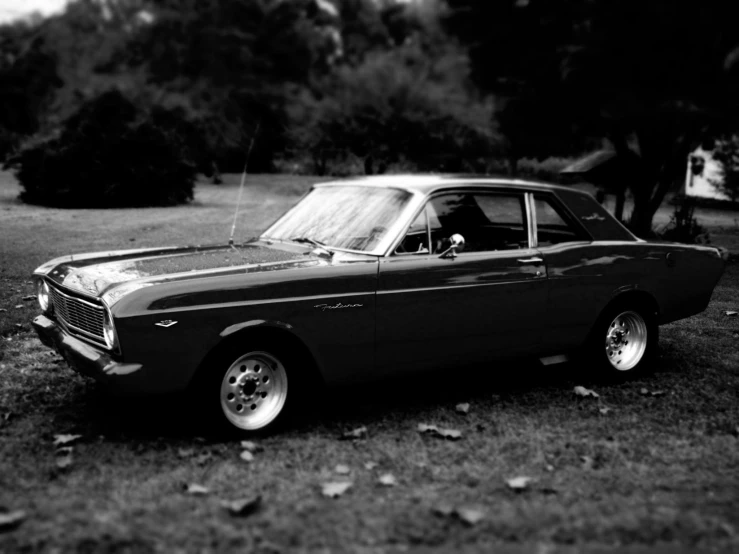 a black and white image of an old car