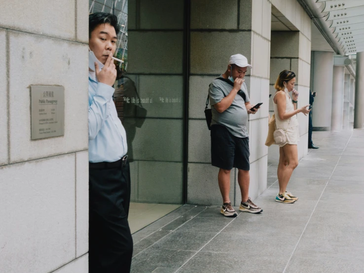 two people are standing on a side walk