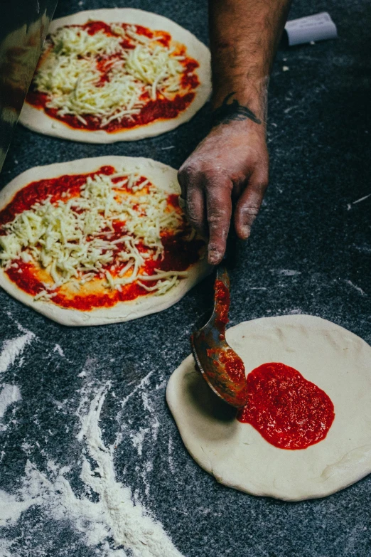 there are two pizzas being prepared to be cooked