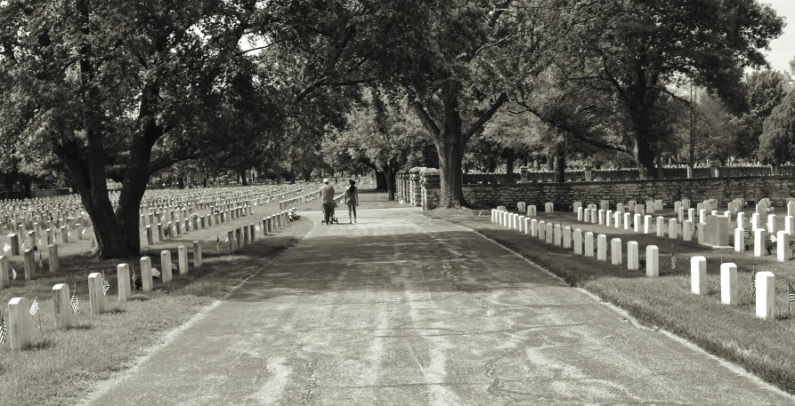 black and white po of people standing in a cemetery