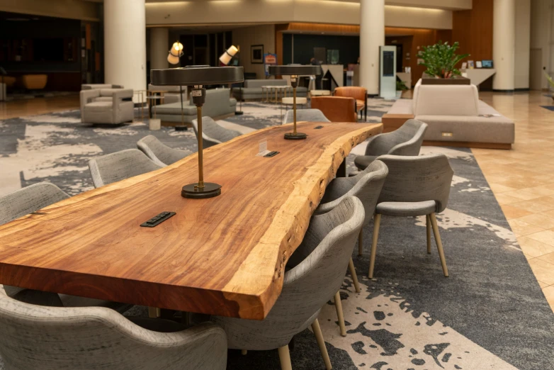 a large conference room with gray chairs and wooden table