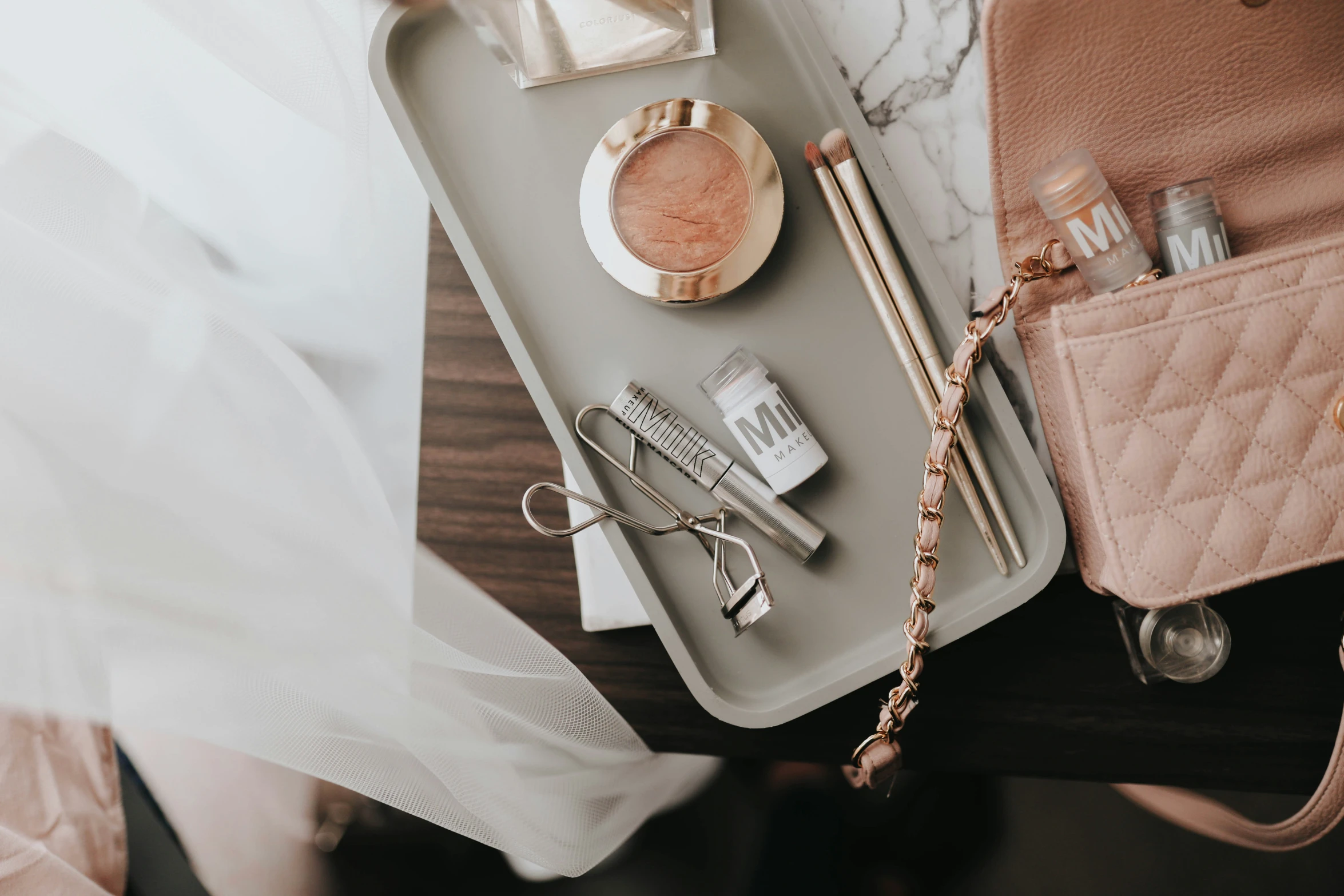 personal items and accessories are arranged on a tray