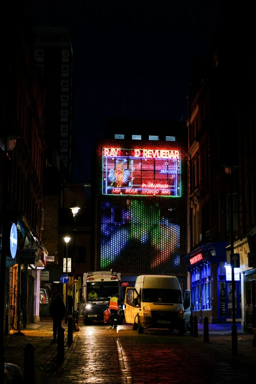 a city street has billboards at night time