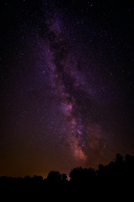 the stars move across the night sky as a couple sit and observe