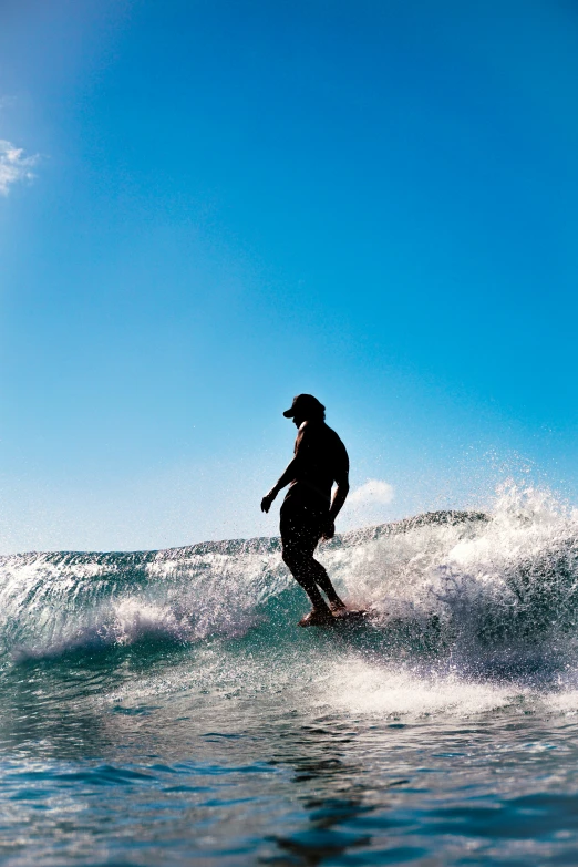 a man rides a surfboard on top of a wave