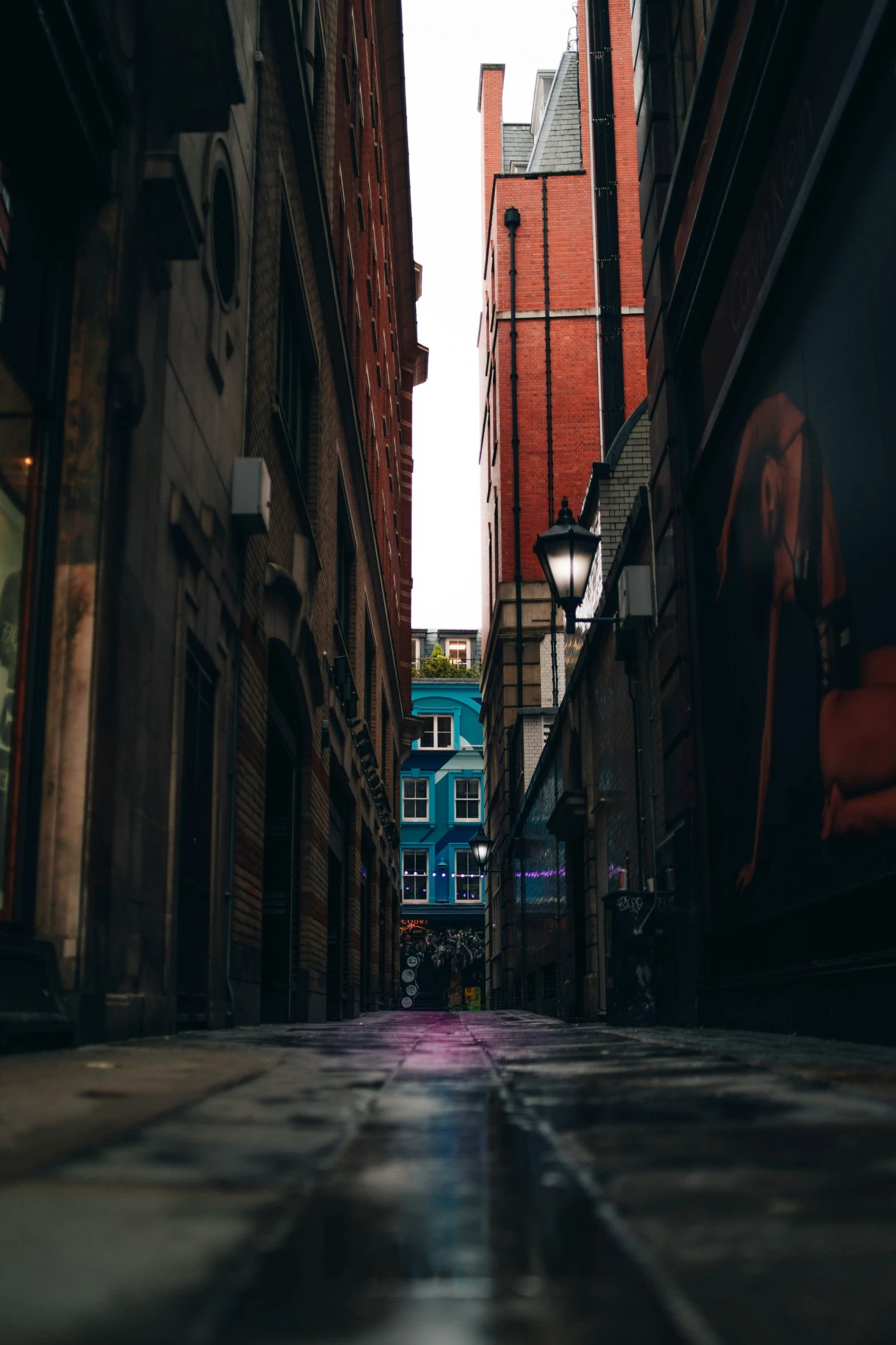 a street in front of buildings with an umbrella on