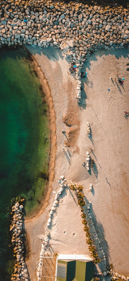 an aerial view of a beach with many stones in it